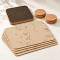 Saphire Cork Table Set for 4, four pale ivory cork placemats, six natural round cork coasters and dark square trivet — premium studio hero