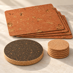 Angled studio view of four Iceberg Red rectangular placemats, six natural cork coasters and one dark round trivet