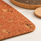Macro detail of Iceberg Red cork placemat 3 mm profile and red cork flecks, with natural coaster and dark trivet edges