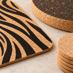 Macro detail of black zebra-pattern print on natural cork placemat, natural coaster and thick dark cork trivet