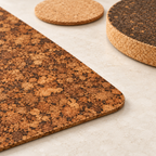 Close-up of Samba agglomerated cork placemat texture with natural light coaster and thick dark cork trivet.