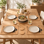 Four Table Service printed cork placemats beneath plates on a refined dining table, with natural coasters and dark cork trivet.