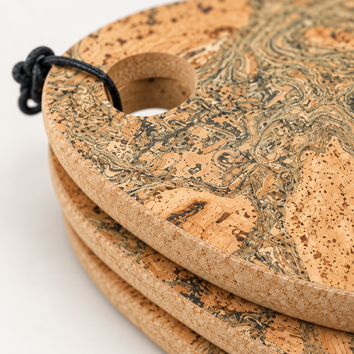 Pebble cork trivet - close-up of natural marbled cork texture, edge and hanging loop