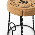 Macro detail of the natural cork seat, decorative top marking and twisted black metal structure