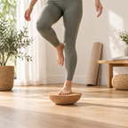 Cork Half-Moon Balance Board used with one foot on the flat top and curved base contacting a level floor