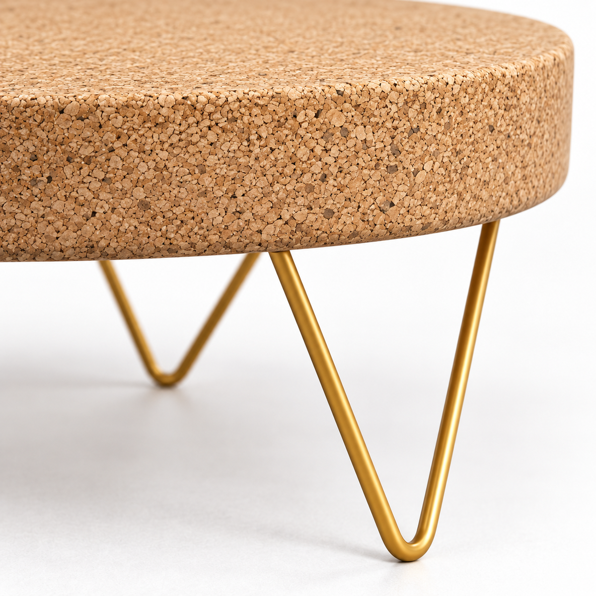 Macro detail of natural cork tabletop edge and gold-tone zig-zag metal leg structure