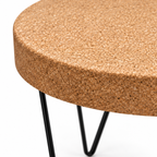 Macro detail of natural cork tabletop edge and black metal zig-zag leg structure