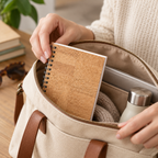 Cork Spiral Notebook | Natural Finish — compact notebook being placed in a bag
