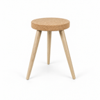 Cork Stool with 3 Wooden Legs, angled studio view showing round cork seat and three light wooden legs