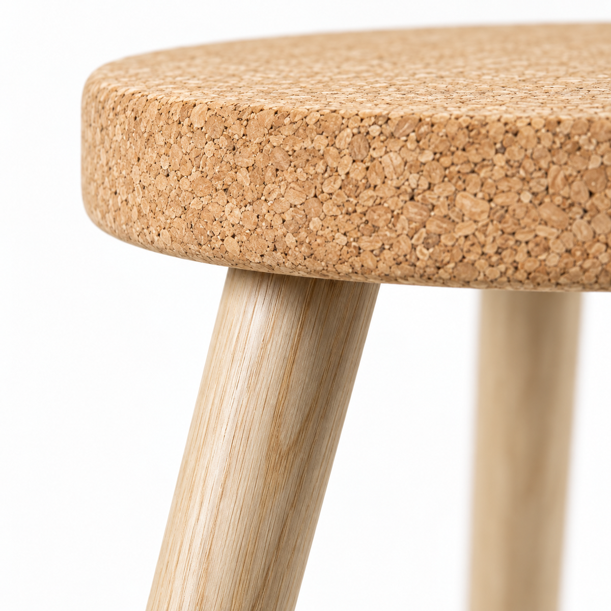 Macro detail of natural cork seat edge and light wooden leg