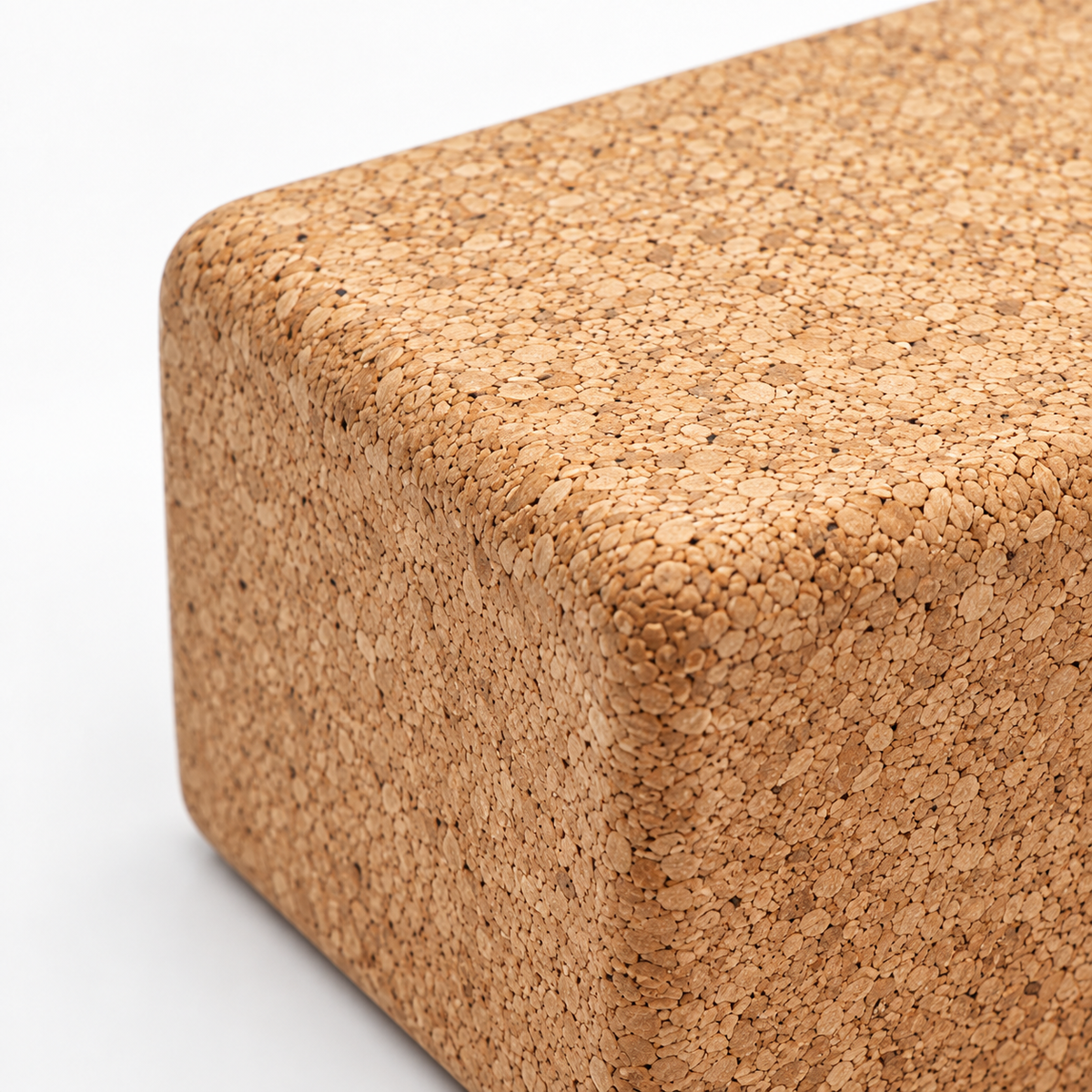 Macro detail of natural cork texture and rounded edge on cork yoga block