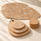 Pick Snow White table set photographed at an angle, showing four 3 mm placemats, three 15 mm trivets and six cork coasters