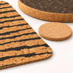 Close-up of Tiger patterned cork placemat, natural coaster and 20 mm dark round cork trivet