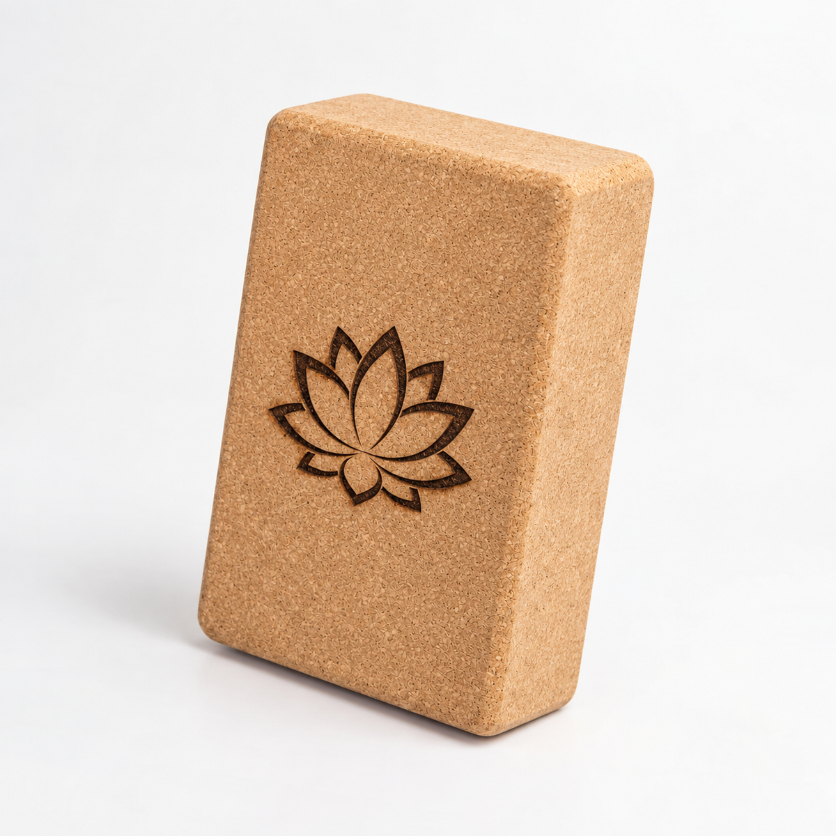 Custom laser engraved cork yoga block, three-quarter studio view with an example lotus design.