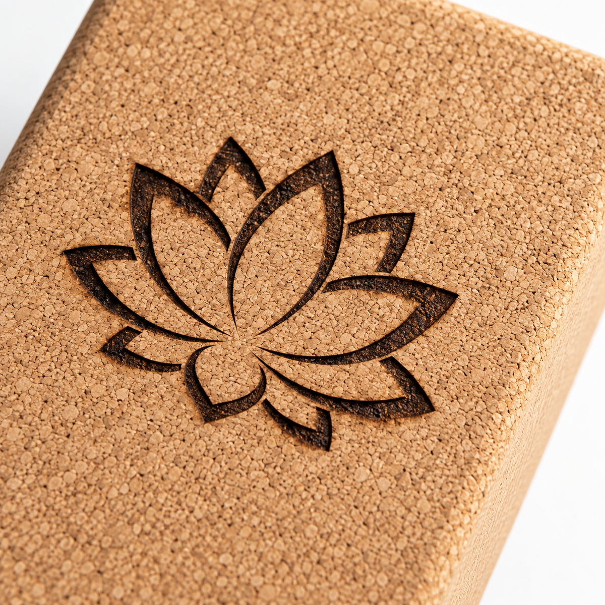 Close-up of cork texture and laser engraved lotus detail on the custom yoga block.