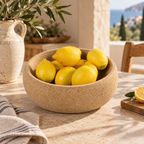 Deep cork fruit bowl styled with lemons in a warm Mediterranean interior