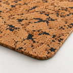 Macro close-up of Fjord Black cork placemat surface, rounded corner and thin edge
