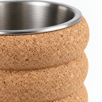 Macro detail of natural cork texture, rounded fluted segments and stainless-steel rim