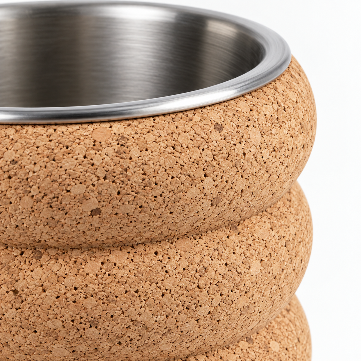 Macro detail of natural cork texture, rounded fluted segments and stainless-steel rim