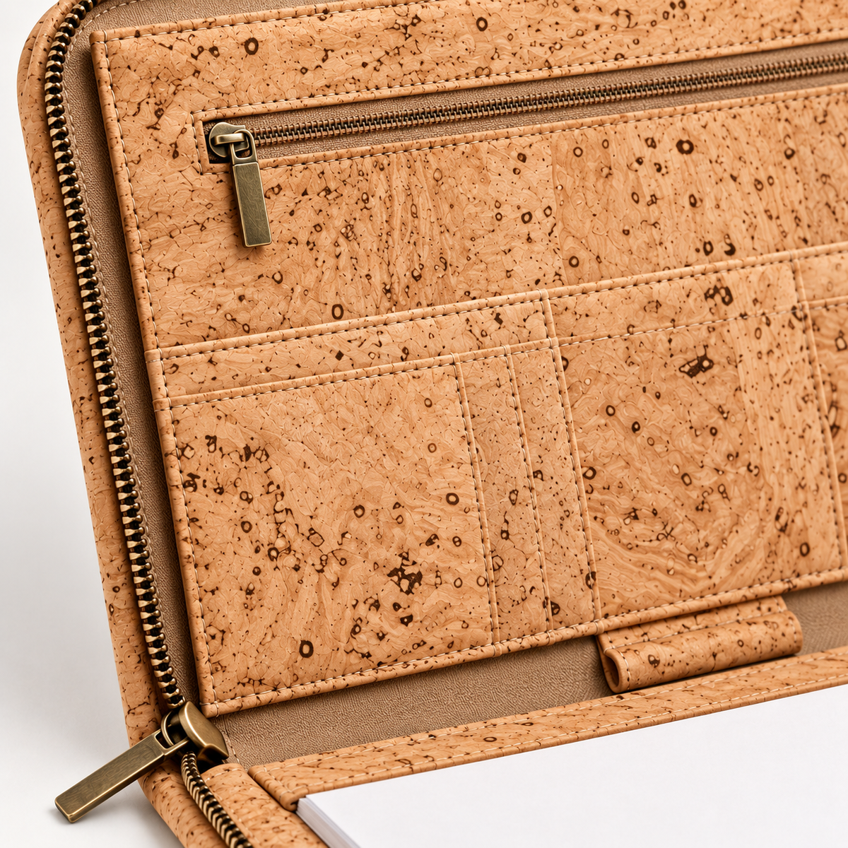 Close-up of the natural cork surface, stitching and interior zip on the business portfolio.