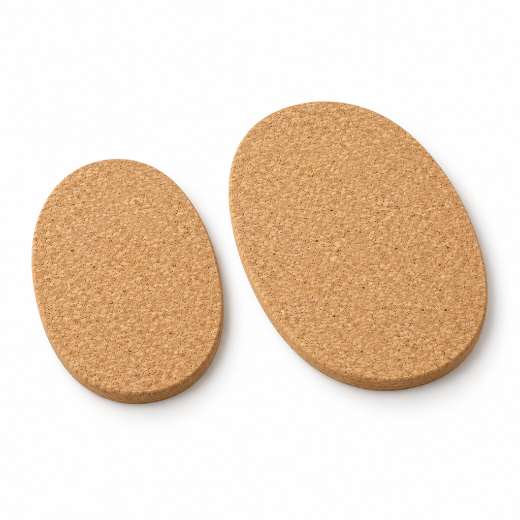 Oval cork trivet set of 2, loose pieces in two sizes, angled studio view showing 9 mm thickness