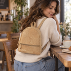 Petite Natural Cork Mini Backpack in a cozy cafe setting