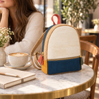 Petite Pop Cork Mini Backpack in a cozy cafe setting