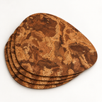 Stack of four Pick Angola cork placemats showing the organic teardrop profile