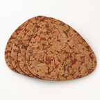 Stack of four Pick Fjord Maroon cork placemats showing the organic teardrop profile