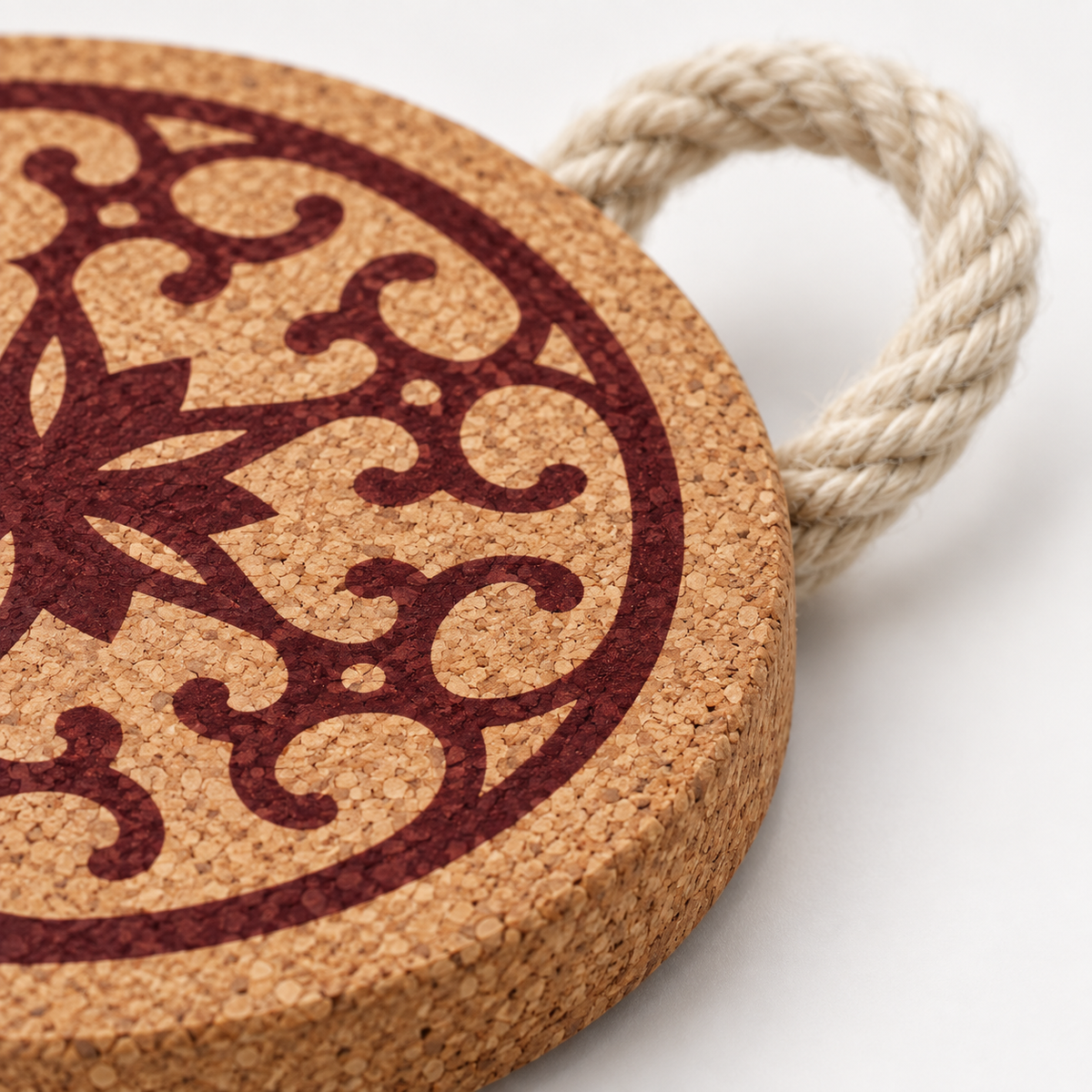 Close-up of Portuguese Tile Red Cork Trivet cork texture, red pattern and rope loop