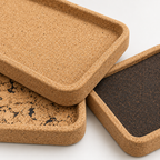 Macro detail of rectangular cork serving tray texture, raised rim and rounded edge