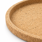Macro detail of round cork serving tray texture, raised rim and 30 mm profile
