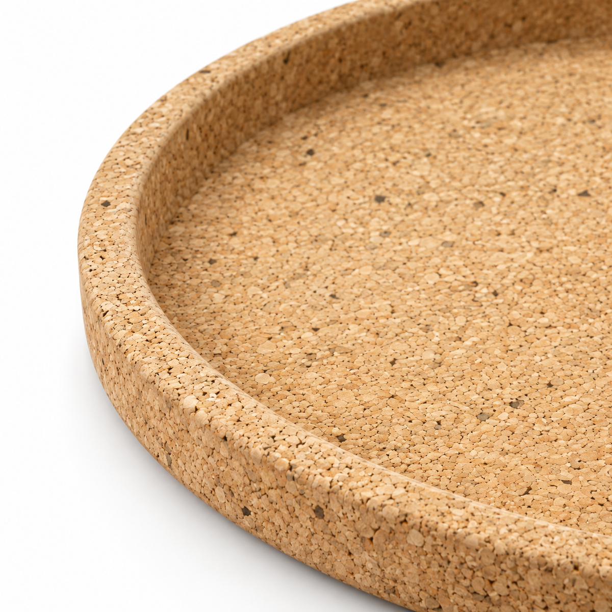 Macro detail of round cork serving tray texture, raised rim and 30 mm profile