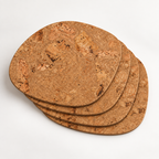 Stack of four Rounded Square Iceberg Natural cork placemats showing rounded-square profile and thin edges