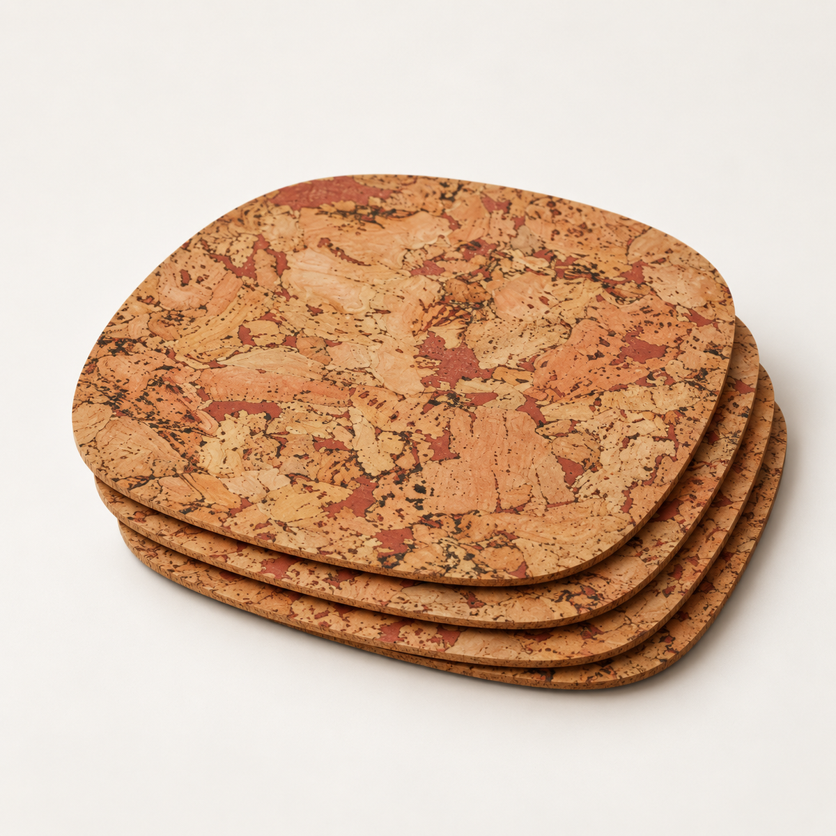 Stack of four Rounded Square Maroon cork placemats showing rounded-square profile and thin edges