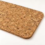 Macro close-up of small rectangular cork placemat surface, rounded corner and thin edge