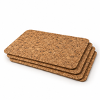 Stack of four small rectangular cork placemats showing thin profile and rounded corners